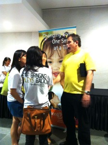 Justin, a representative from Operation Smile Singapore, talking to the audience after the show
